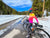 Women cycling through Yellowstone in Winter