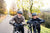 A senior couple pausing while riding ebikes along a wooded road